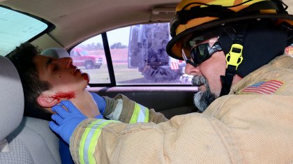 A Lemoore Volunteer Fire Department firefighter checks on a possible victim.